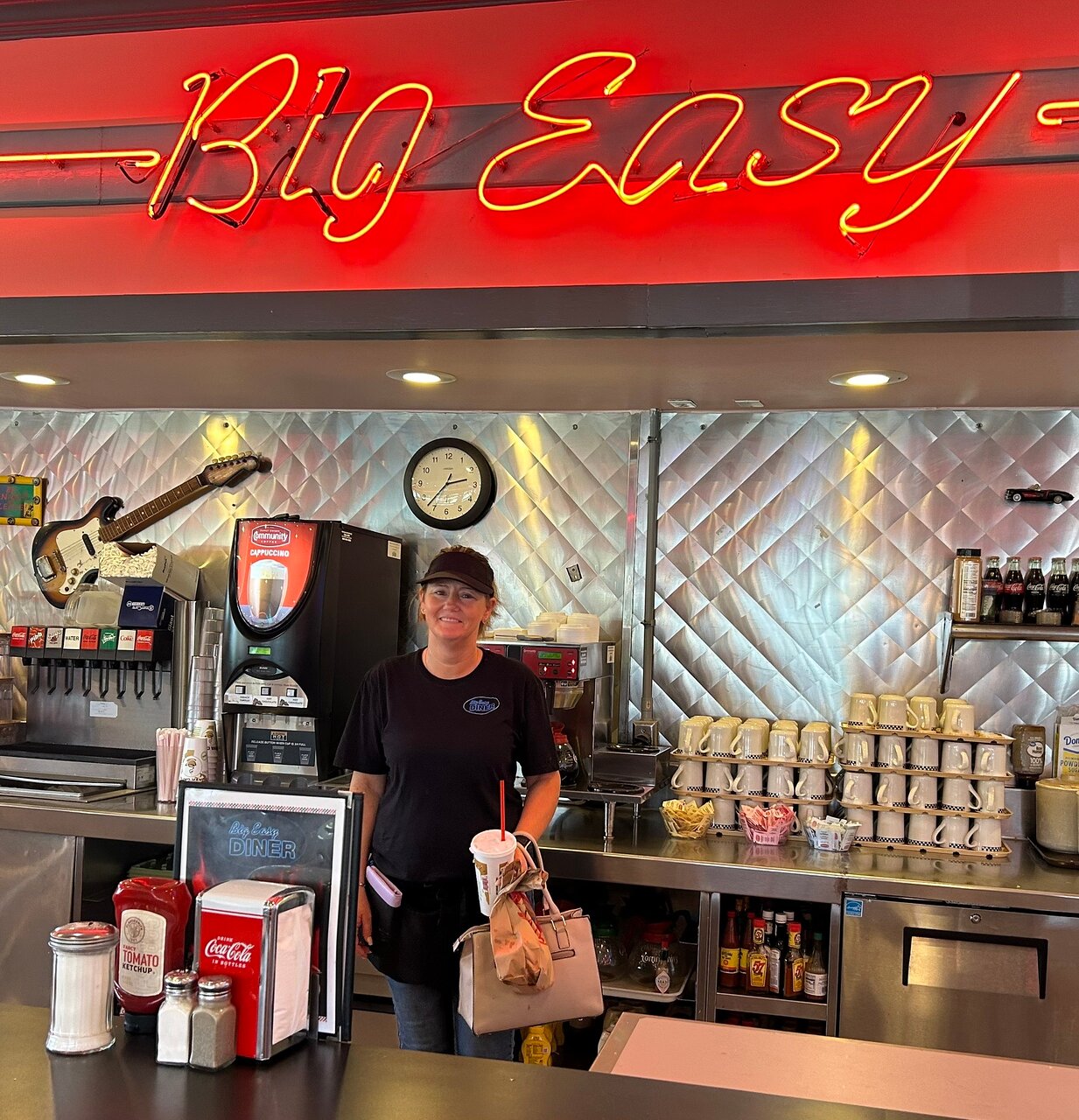 Server at the Big Easy Diner counter with takeout order
